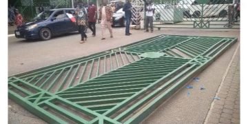 Angry protesters pull down NASS gate